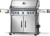 Stainless steel grill with double-door storage, blue-lit control knobs, side burners, and a built-in temperature gauge on the lid.