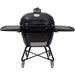 A black ceramic charcoal grill with foldable side tables, a cradle stand with locking casters, and a built-in temperature gauge