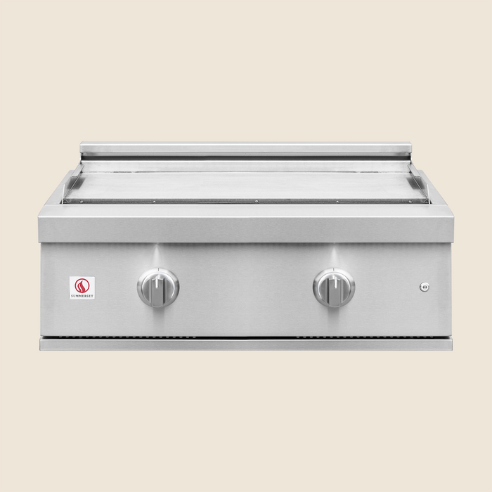 Stainless steel outdoor griddle with dual control knobs and smooth flat cooking surface.