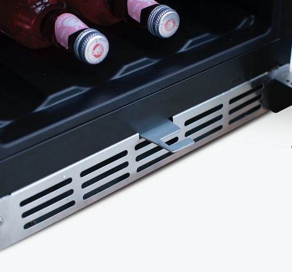 Close-up of a refrigerator vent grille with bottles stored inside on the bottom shelf, showcasing ventilation and storage space.