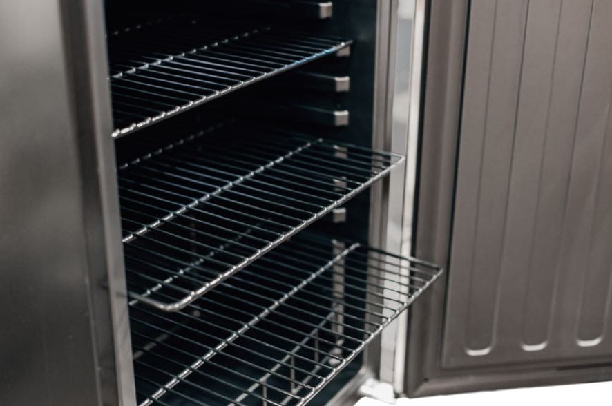 Open refrigerator stocked with various beverages, including cans and bottles, organized on multiple shelves with a sleek black interior.