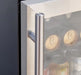 Stainless steel door handle of a glass-front beverage fridge, showcasing a sleek and modern design with beverages inside.