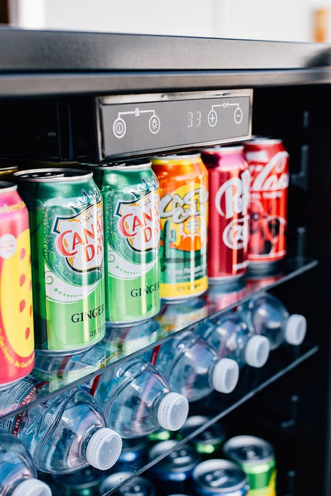 Interior view of a refrigerator showcasing shelves filled with cans, bottles, and a temperature control panel at the top.