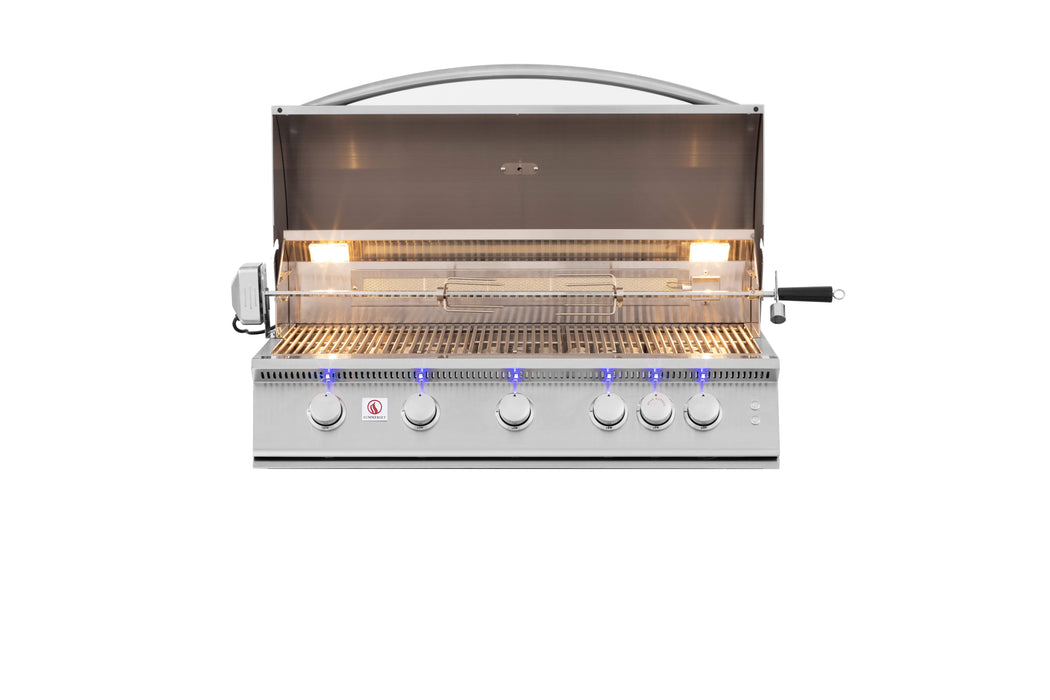 Stainless steel gas grill with open lid, internal lights, rotisserie kit, five control knobs with blue LED lights, and grilling area.