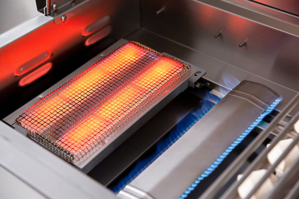 Close-up of a stainless steel grill with a glowing infrared searing burner and blue flames visible under the grill components.