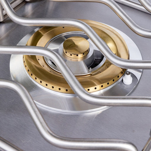 Close-up of stainless steel outdoor side burner with brass ring and heavy-duty cooking grate.