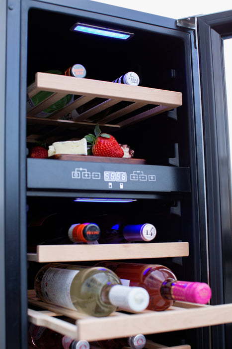 Close-up of a beverage cooler with shelves, featuring wine bottles, strawberries, and cheese under soft interior lighting.