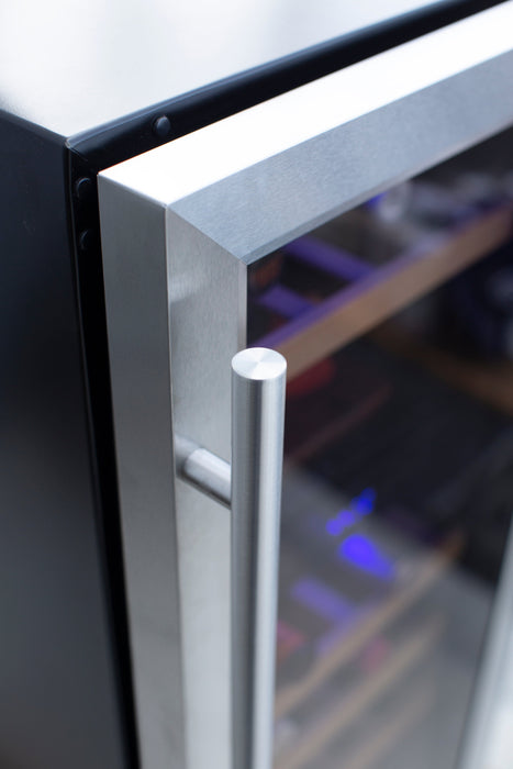 Close-up of a stainless steel cooler door handle with a glass panel, showing shelves and faint blue interior lighting inside.