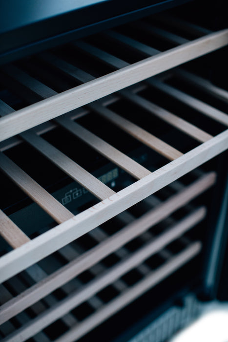 Close-up of shelves inside a cooler, showing the slatted design and partial view of the interior control panel.