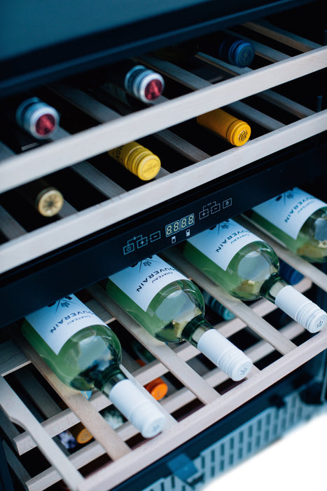 A wine cooler with shelves stocked with assorted wine bottles, featuring a digital control panel and soft interior lighting.