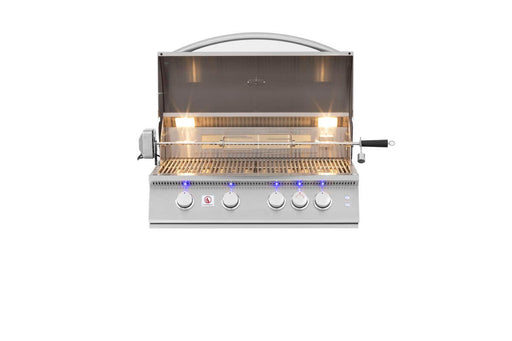 Open stainless steel grill with illuminated interior, rotisserie setup, five control knobs with blue LED lights, and grilling surface.