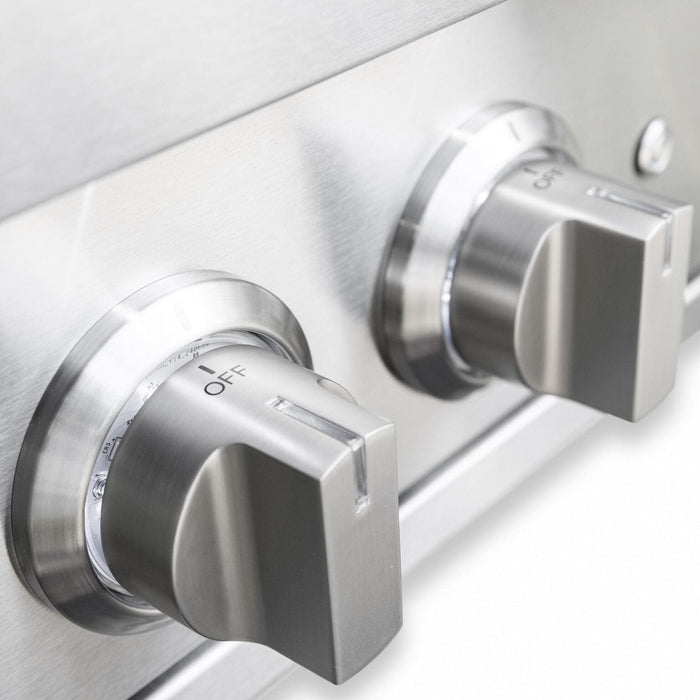 Close-up of stainless steel control knobs on an outdoor burner showing polished finish and precise temperature settings.