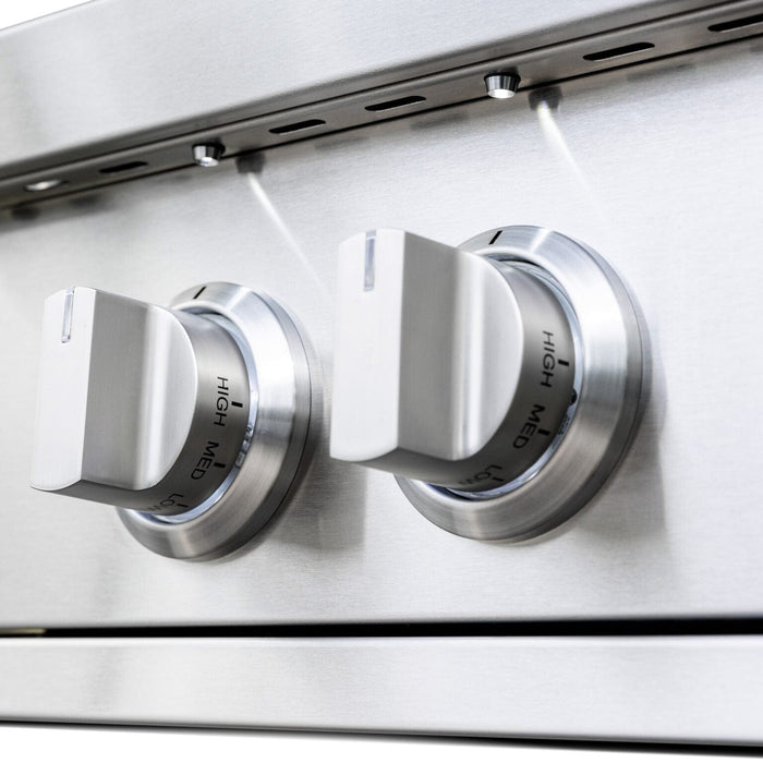 Close-up of stainless steel control knobs with high, medium, and low settings on an outdoor gas cooking appliance.