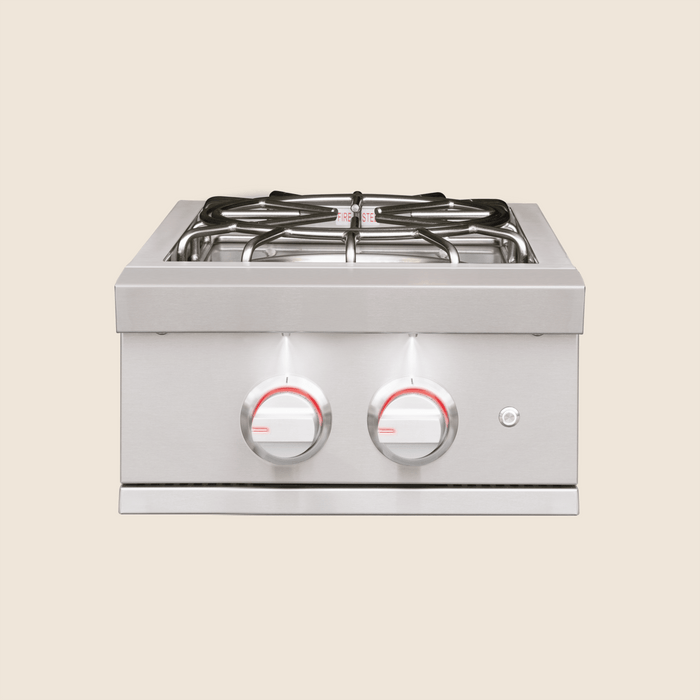 Stainless steel outdoor side burner with illuminated control knobs and heavy-duty cooking grates for outdoor kitchens.