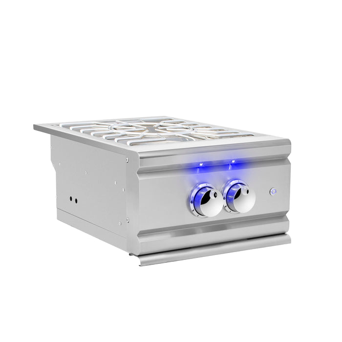 Angled view of a stainless steel double side burner with blue LED-illuminated control knobs and cast grates for outdoor cooking.