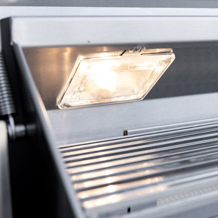 Close-up of built-in halogen light inside stainless steel grill for improved visibility while cooking.