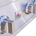 Close-up of stainless steel grill control knobs and logo plate on sleek metallic front panel.