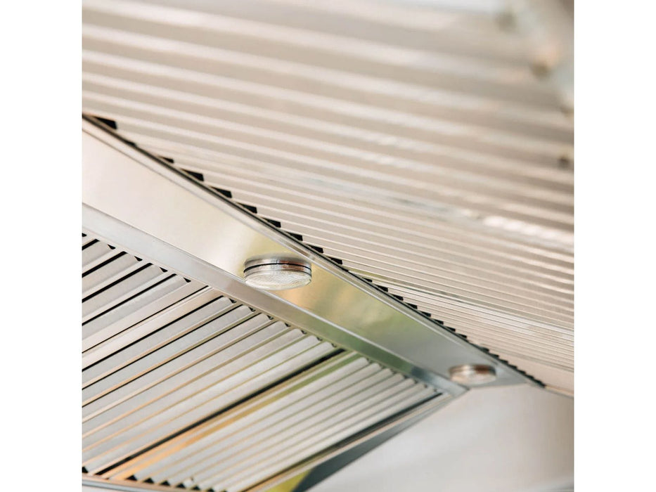 A close-up of a stainless steel vent hood's slatted filters, showcasing a smooth metallic finish and efficient design for airflow.