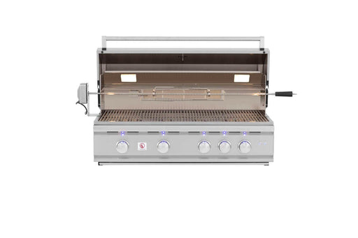 Open stainless steel grill showing cooking grates, rotisserie attachment, built-in lights, and five illuminated control knobs.