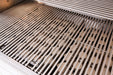 Close-up of stainless steel grill grates showing clean, evenly spaced rods with a view of the burners beneath for cooking performance.