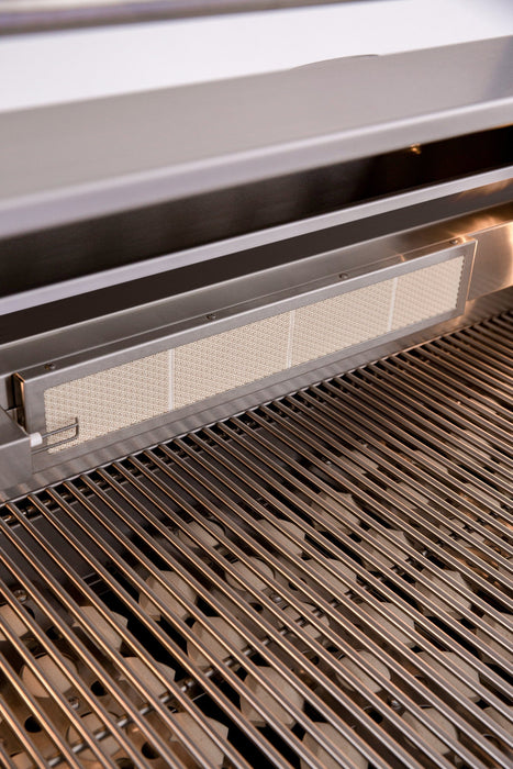 Close-up view of an outdoor grill with stainless steel grates and an infrared heating element in the back panel.