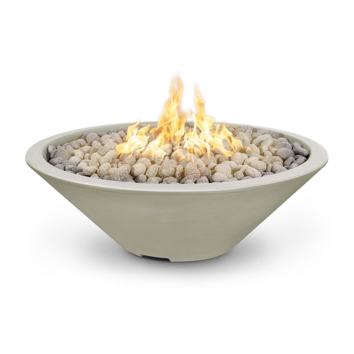 Cazo gas fire pit in white color made of GFRC concrete with a narrow ledge, filled with lava rocks and featuring a sleek, modern design with flames.