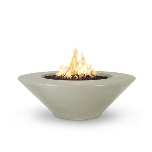 Cazo gas fire pit in ash color made of GFRC concrete with a wide ledge, filled with lava rocks and featuring a sleek, modern design with flames