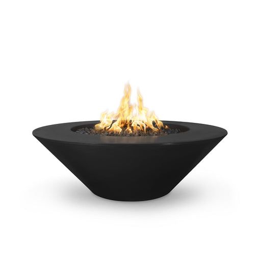 Cazo gas fire pit in black color made of GFRC concrete with a wide ledge, filled with lava rocks and featuring a sleek, modern design with flames