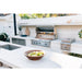 American Made Grills Alturi built-in gas grill installed in a modern outdoor kitchen with side burner and stainless steel storage