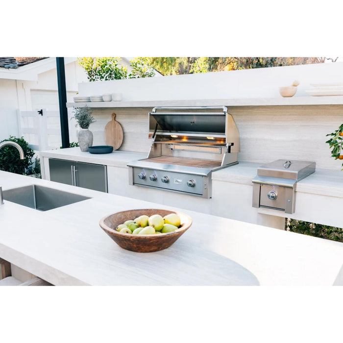 American Made Grills Alturi 42-inch built-in gas grill installed in a modern outdoor kitchen with stainless steel storage and side burner.
