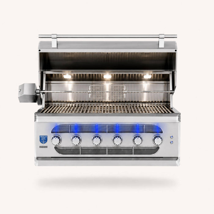 American Made Grills Muscle 42-inch built-in hybrid grill with open hood, stainless steel cooking grates, rotisserie system, interior lights, and six control knobs.