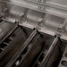 American Made Grills Muscle hybrid grill interior showing heavy-duty stainless steel burners and multi-fuel trays for gas, charcoal, and wood cooking.