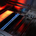 American Made Grills Muscle hybrid grill interior showing an infrared sear burner, stainless steel gas burner, and multi-fuel cooking system.