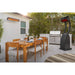 Bromic Tungsten wall-mounted gas patio heater providing radiant warmth beside an outdoor dining area and kitchen
