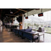 Bromic Tungsten Smart-Heat gas radiant patio heaters ceiling-mounted above lounge seating at a commercial golf entertainment venue