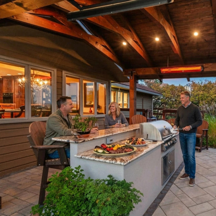 Bromic Platinum Smart-Heat electric radiant heater mounted above a covered outdoor kitchen with built-in gas grill and seating