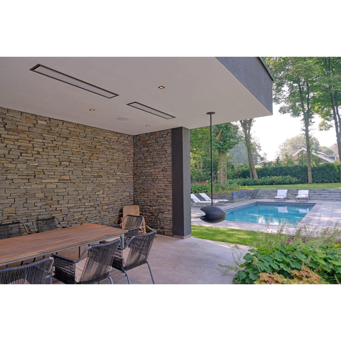 Bromic Platinum Smart-Heat ceiling-mounted electric patio heaters above an outdoor dining area overlooking a swimming pool