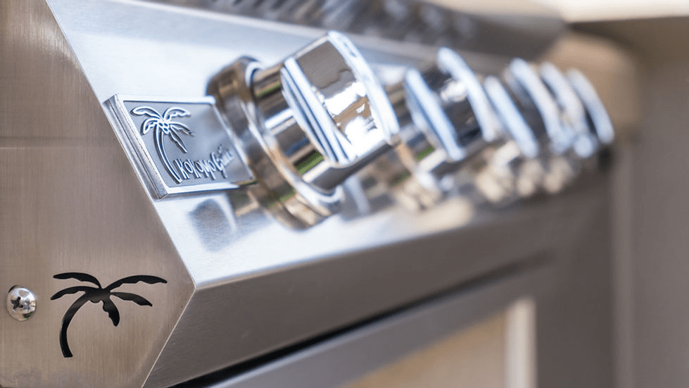 Close-up of stainless steel control knobs on a built-in gas grill, featuring KoKoMo Grills logo and sleek, durable design for precise heat control