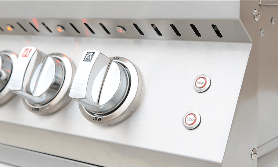 Close-up of stainless steel grill control knobs with LED illumination and buttons for lamp and LED control