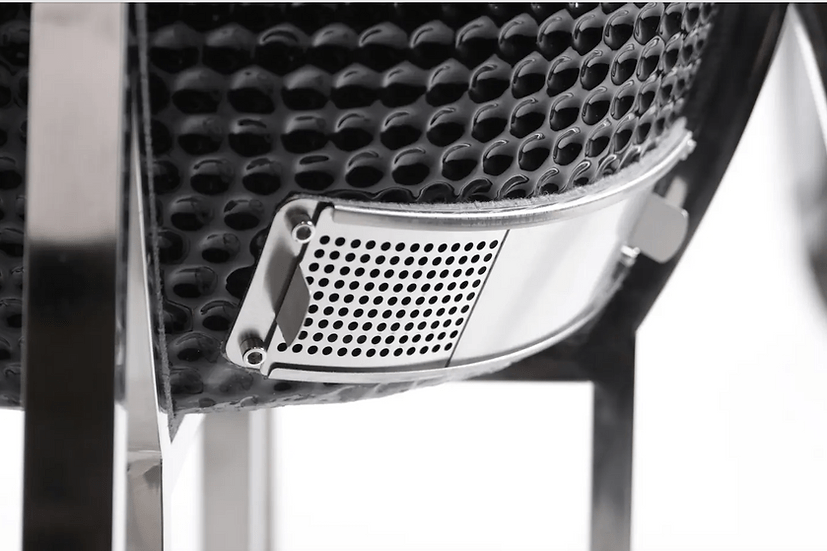 Close-up of the adjustable air vent at the base of a ceramic grill, designed for precise temperature control and efficient airflow management