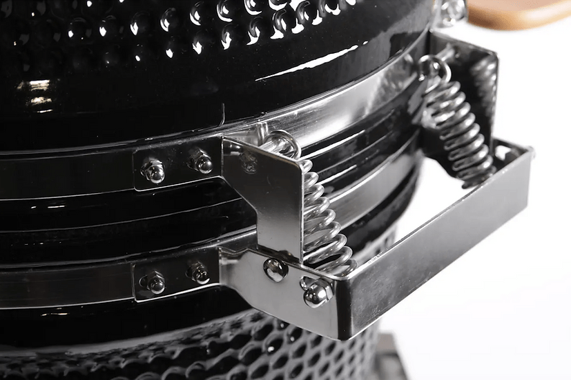 Close-up of the spring-loaded hinge system on a ceramic grill lid, designed for smooth and easy opening and closing during use