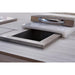 Kokomo Grills built-in stainless steel trash chute installed in an outdoor kitchen countertop with cutting board