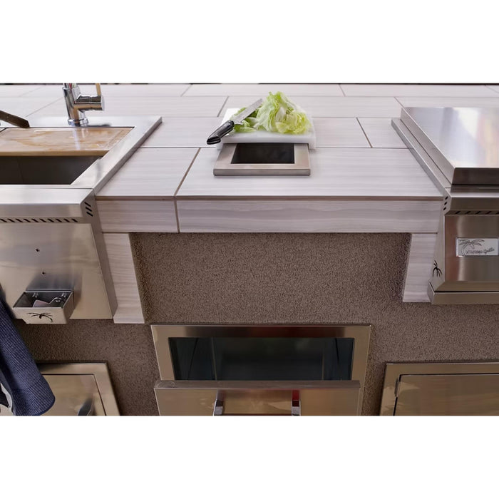 Kokomo Grills built-in trash chute and cutting board installed between outdoor kitchen appliances
