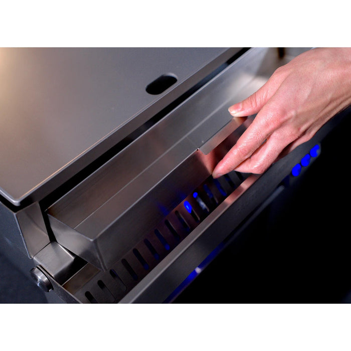 Close-up of Le Griddle Pro Series stainless steel U-shaped gas burner and thermocouple safety sensor beneath the cooking plate.