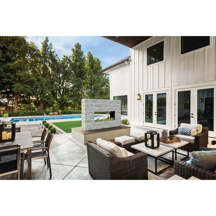 Napoleon Galaxy 50 linear outdoor gas fireplace installed in a modern patio lounge beside a swimming pool and outdoor dining area