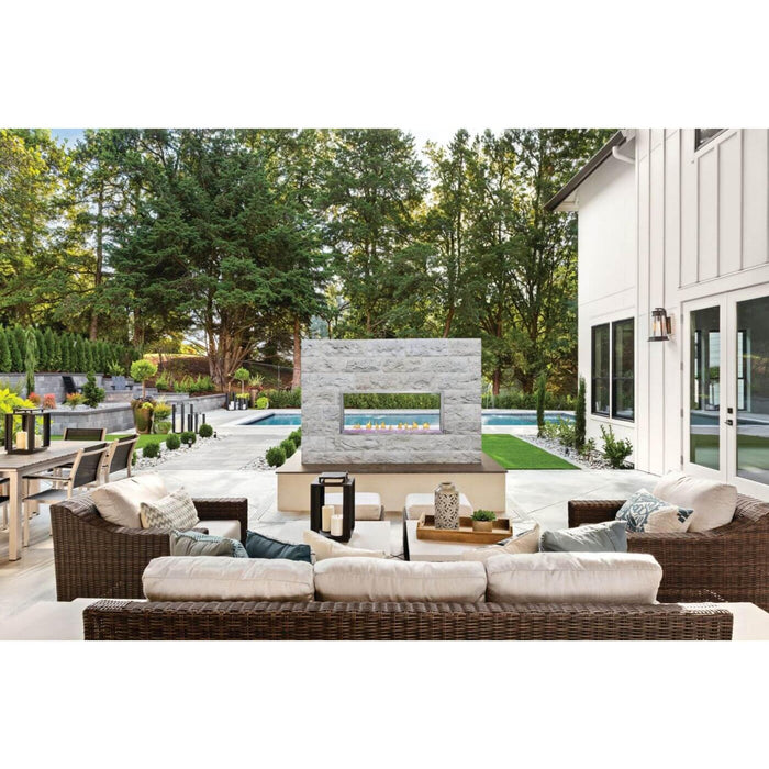 Napoleon Galaxy 50 outdoor gas fireplace built into a stone feature wall overlooking a modern backyard patio and swimming pool