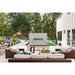 Napoleon Galaxy 50 outdoor gas fireplace built into a stone feature wall overlooking a modern backyard patio and swimming pool