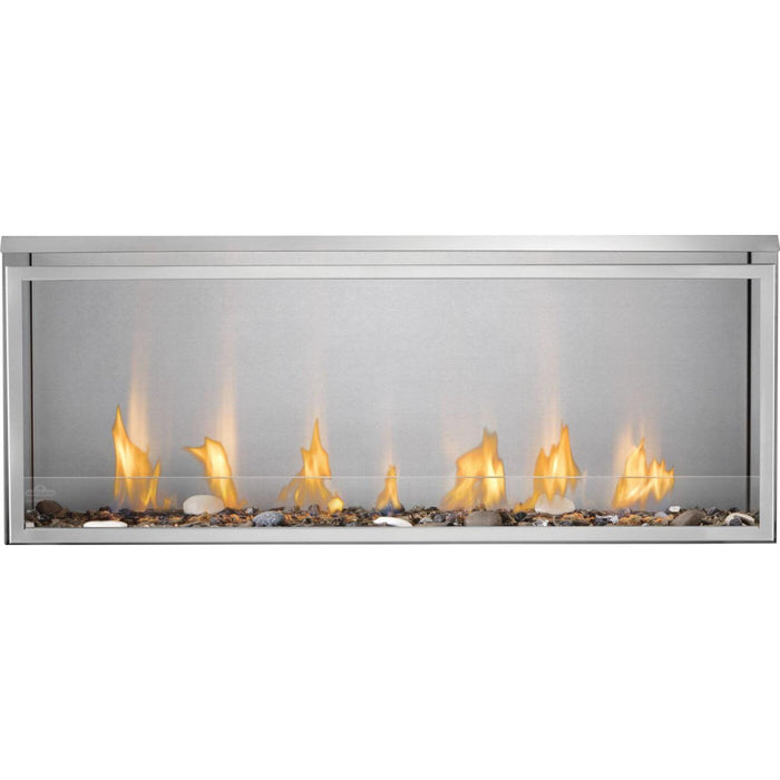 Napoleon Galaxy 50 outdoor gas fireplace with linear flames, glass wind guard, and decorative woodland media in a stainless steel firebox