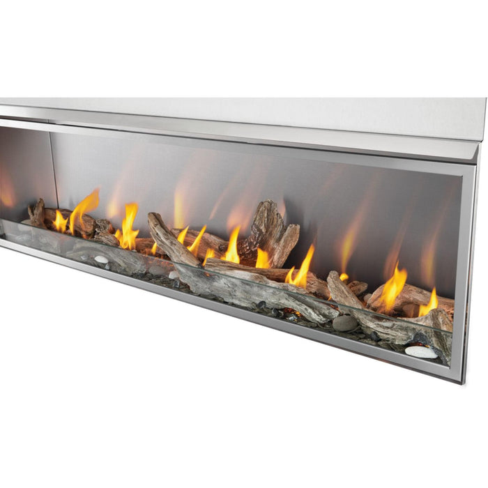 Napoleon Galaxy 74-inch outdoor gas fireplace with decorative driftwood logs, stainless steel finish, and linear flame display.