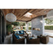Napoleon Galaxy 74-inch linear outdoor gas fireplace installed in a stone feature wall on a luxury covered patio with lounge seating.